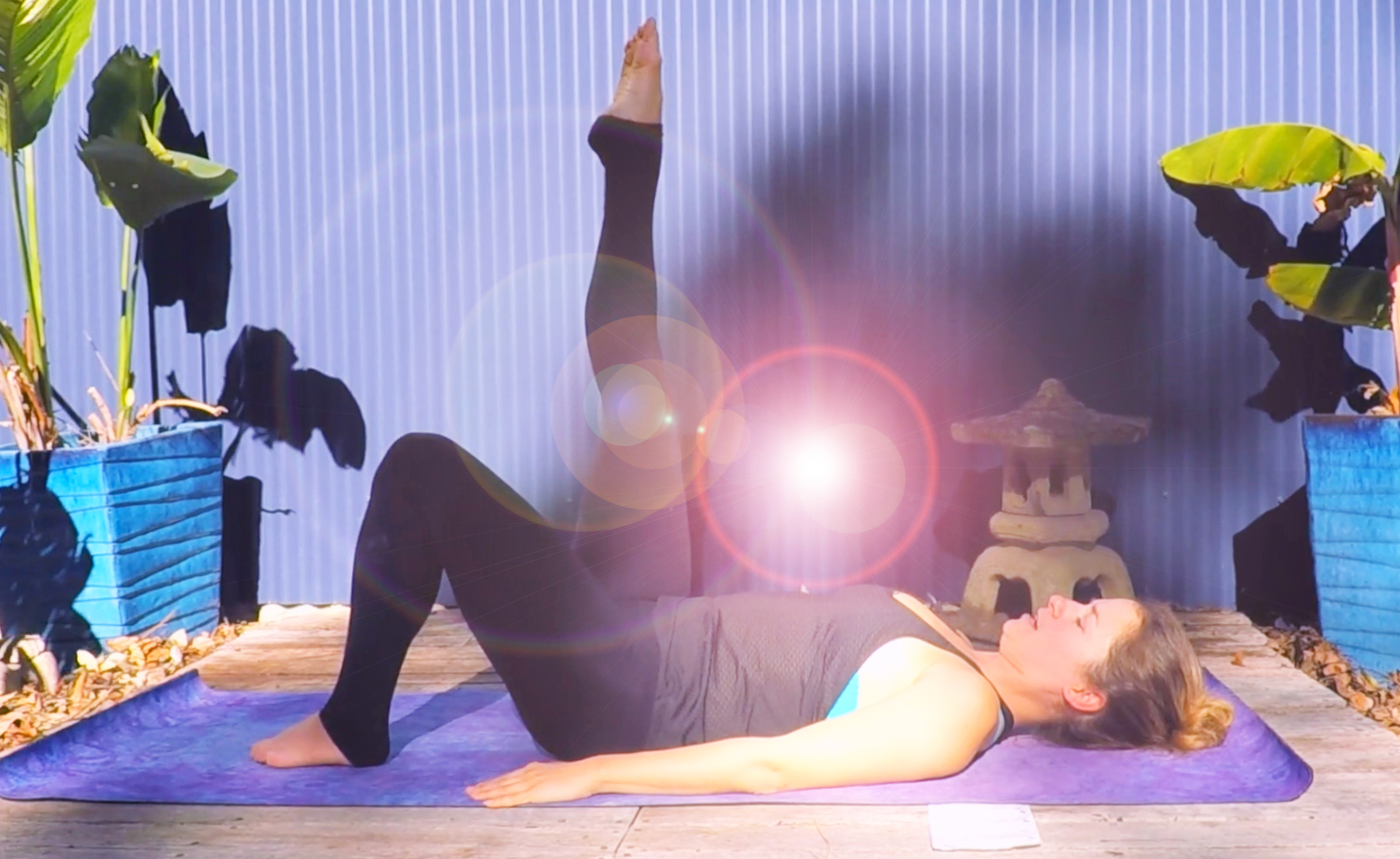 Woman performing a Pilates exercise with sunlight on her