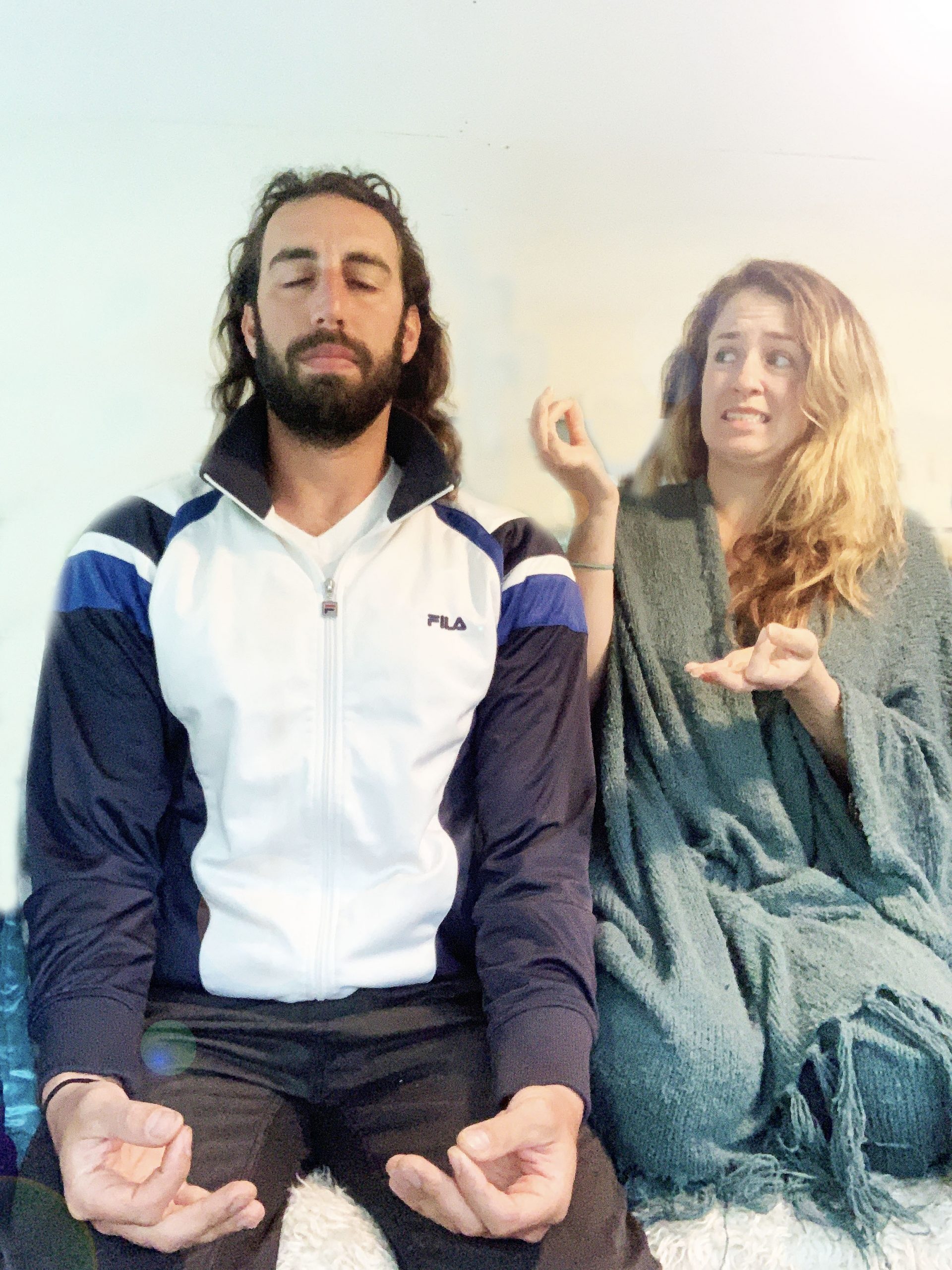 woman looking stressed trying to do meditate next a man deep in meditation