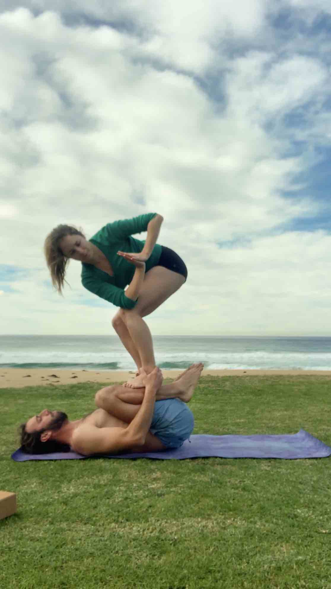 A couple doing acro yoga