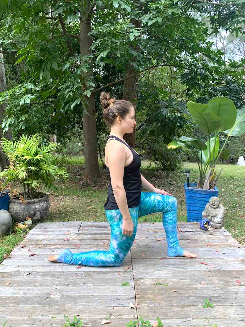 Woman doing a Pilates hip flexor stretch